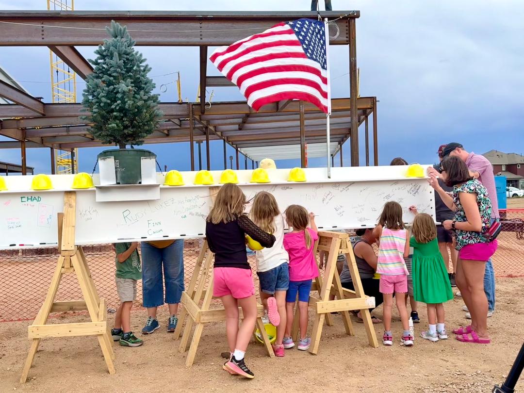 Elementary School 51 kids signing the last beam.